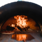 Pizza Cooking In An Outdoor Pizza Oven